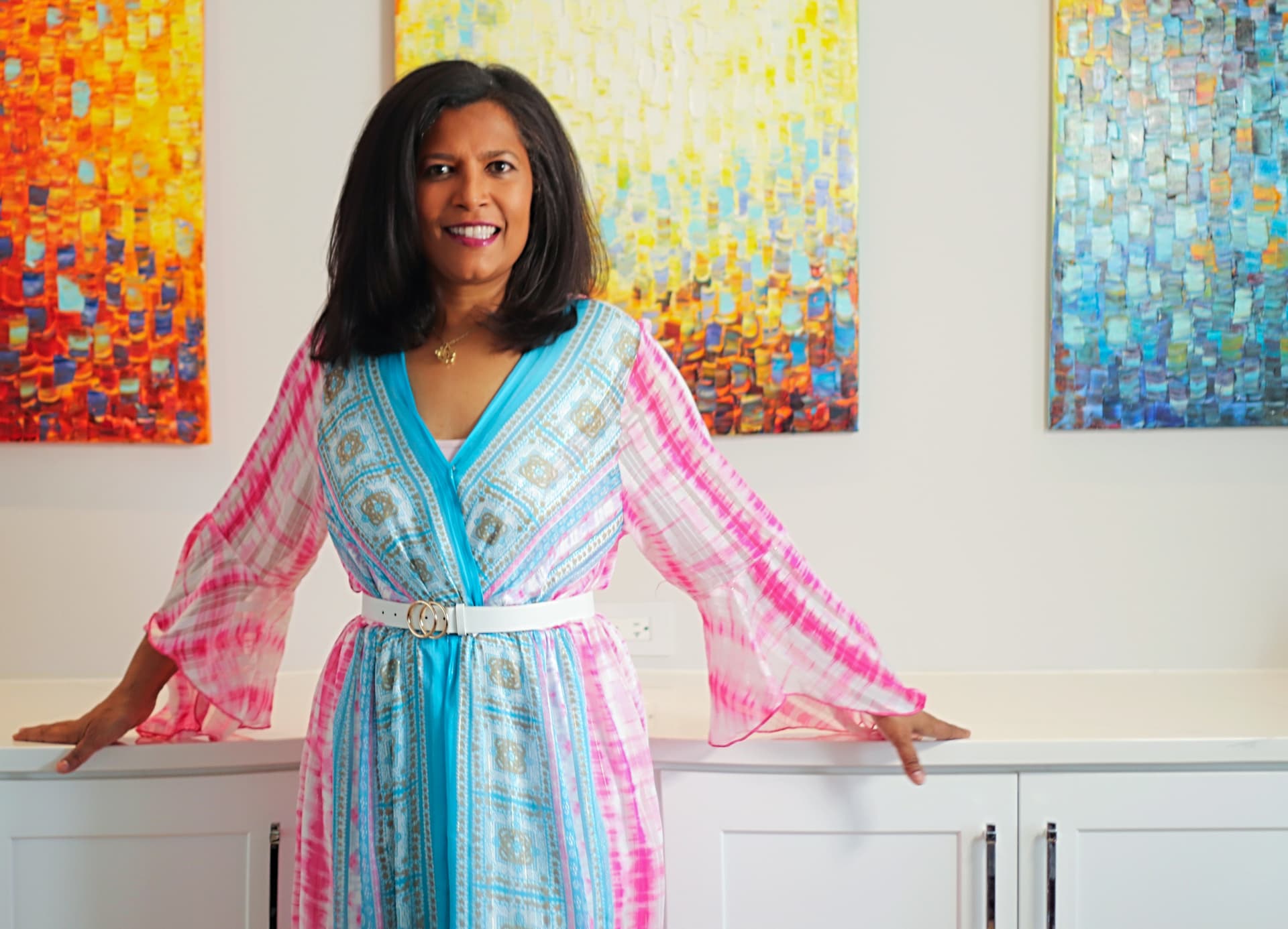 Dr. Gomes in a blue and pink dress